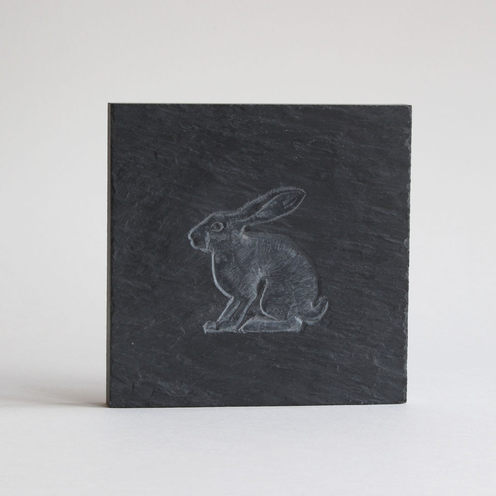 Hare carved on a slate tile