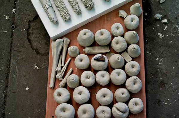 Trays of clay apple sculptures.  Source: Guardian