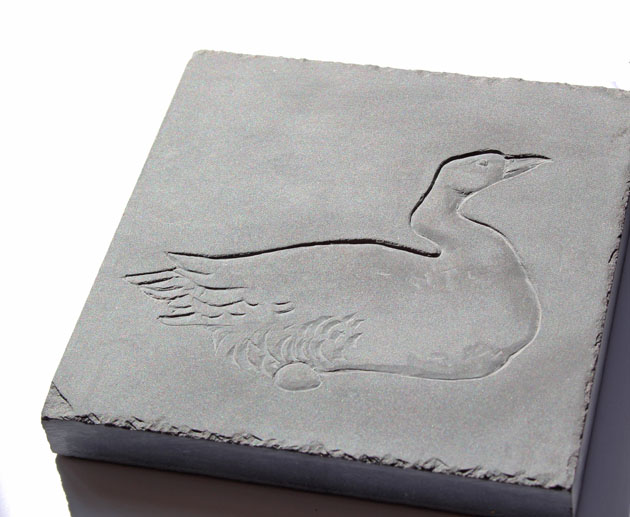 Goose laying carved in slate