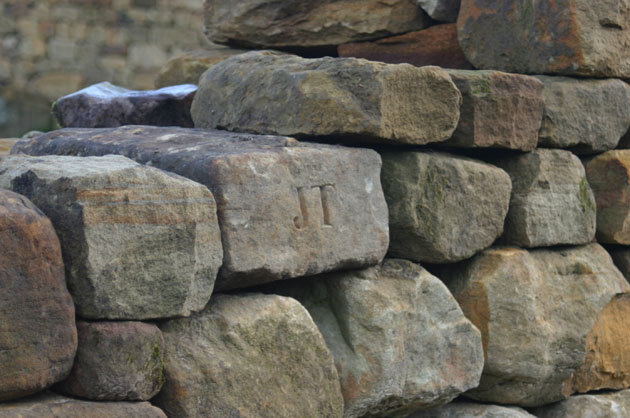 Letters cut in stone at the Dry Stone Wall Maze