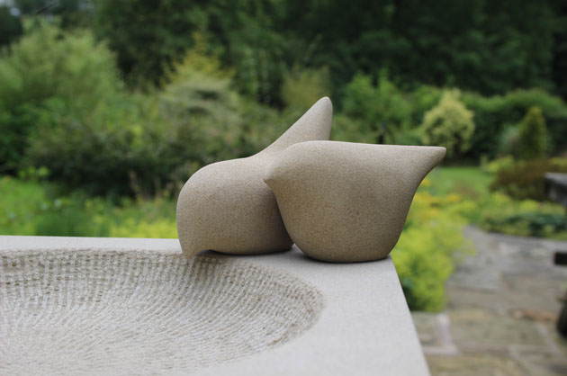 Birdbath carved in stone with two bird sculptures