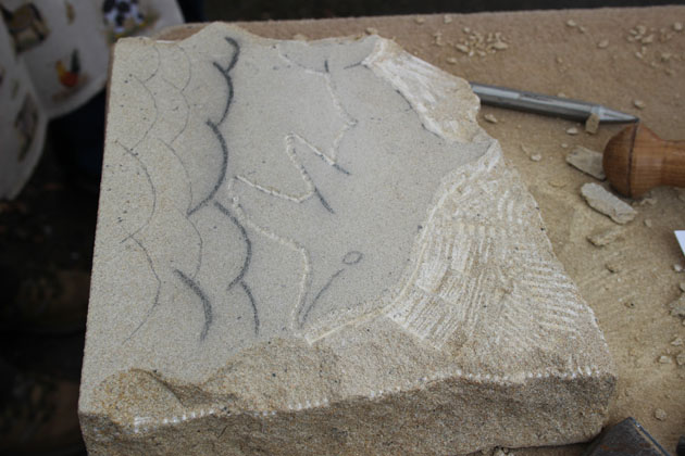 Dolphin being carved during the stone carving workshop at Rural Arts