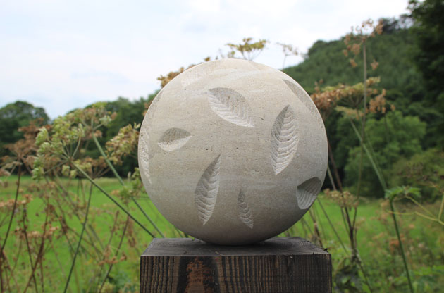 Stone ball carved with decorative leaves