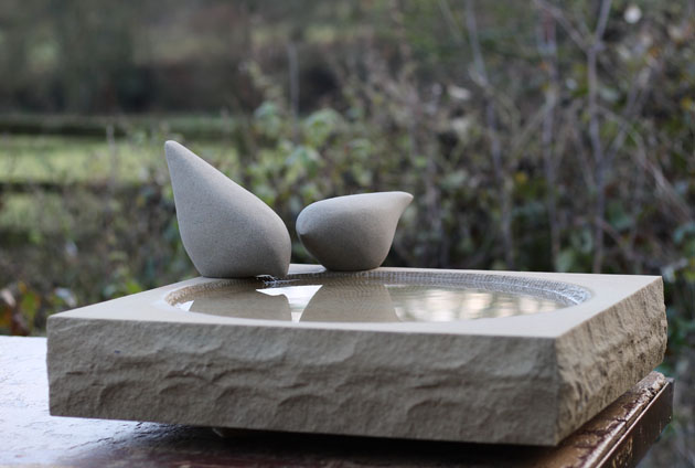 stone-birdbath-with-perching-birds