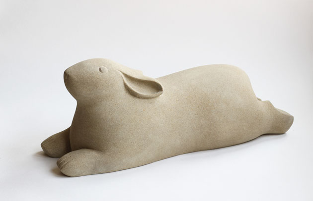 Recumbent Rabbit sculpture carved in sandstone