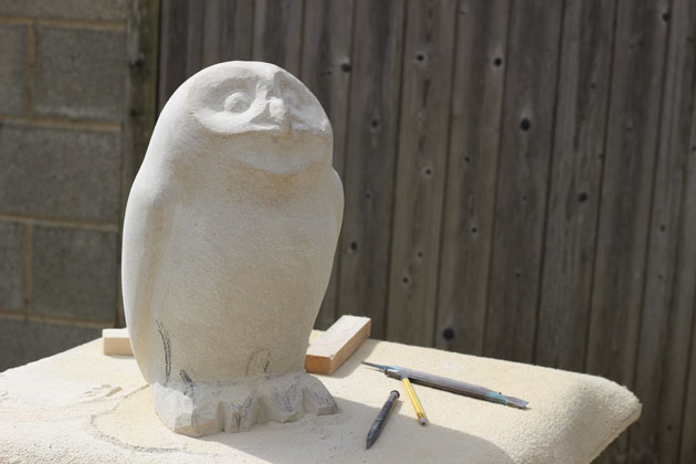 Owl sculpture putting in finishing details