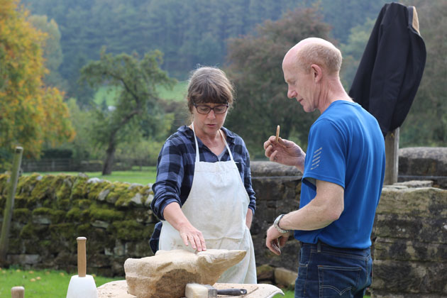 Taking a break and discussing stone carving progress