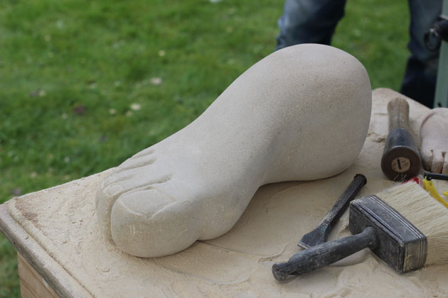 carving a foot in sandstone