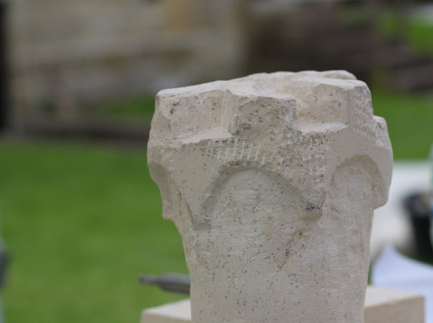 top of the tower being carved in stone