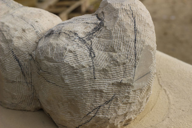 detail of carving progress of two birds sculpture