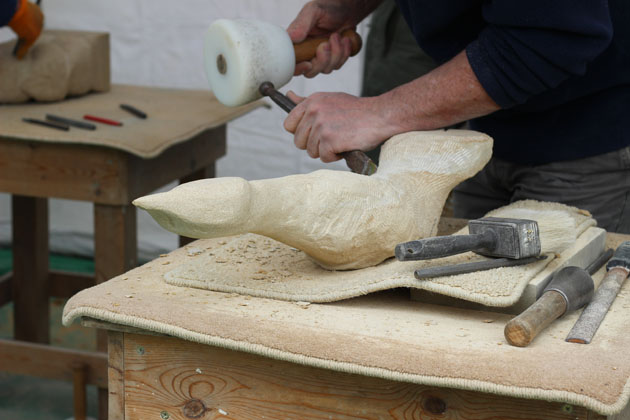 a loon type bird being carved in stone