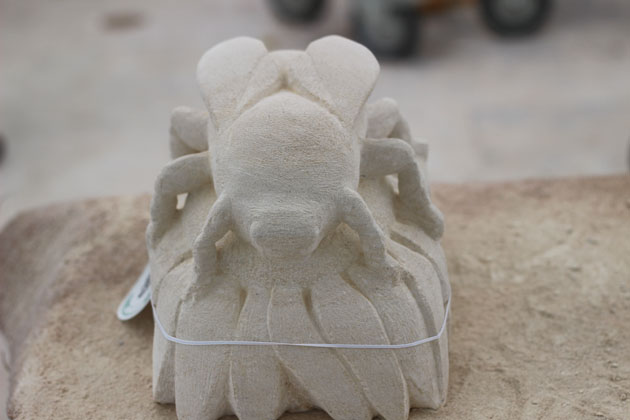 Bee on a flower stone carving