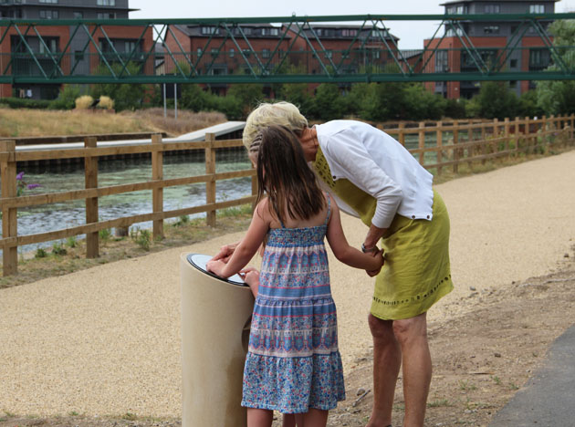 Walkers read the plaque