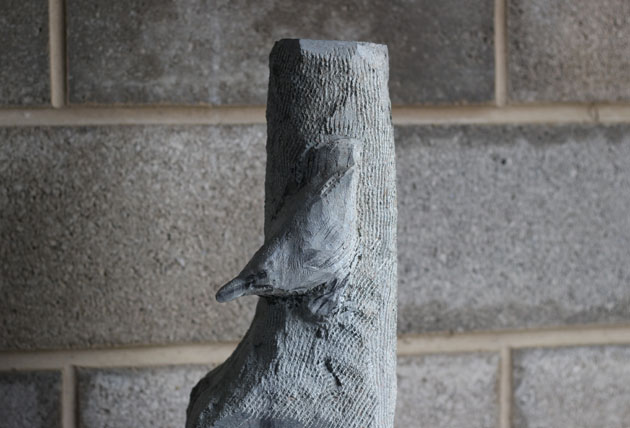 Carving progress nuthatch sculpture in stone