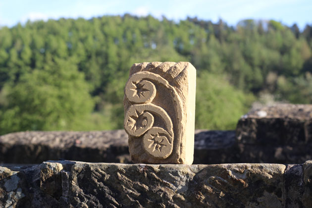 curled fern shape carved in stone