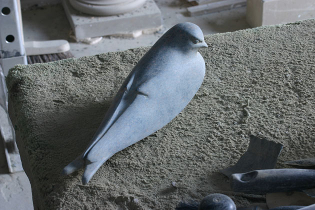 Working on a bird sculpture