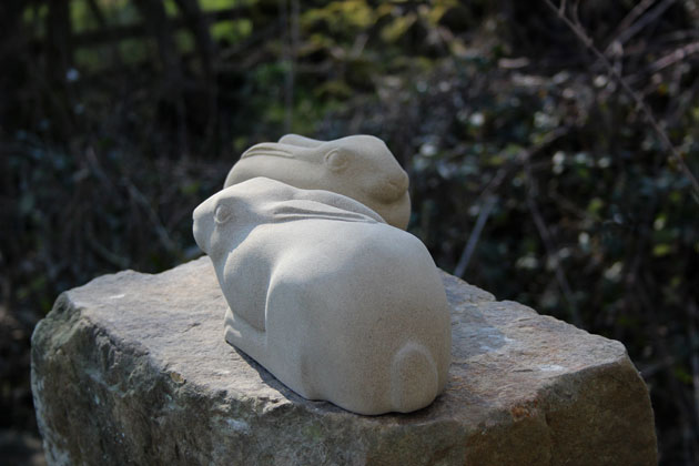 Huddled Hares stone sculpture